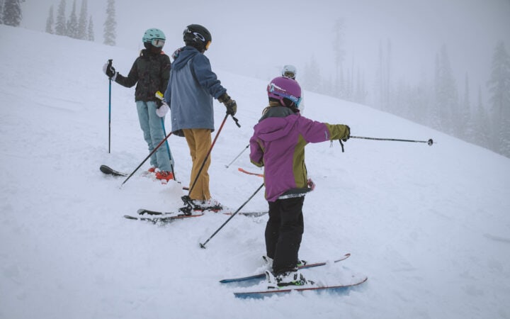 A group of people skiing on a snowy slope.