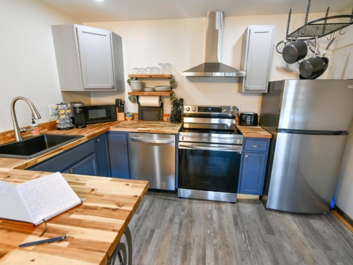 A kitchen with stainless steel appliances and wood counter tops, perfect for a Lost Trail Ski Area vacation rental.