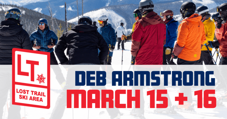 A group of skiers in winter clothing gathers outdoors on snow-covered terrain, with majestic mountains in the backdrop. Text reads: "Deb Armstrong March 15 + 16 at Lost Trail Ski Area.