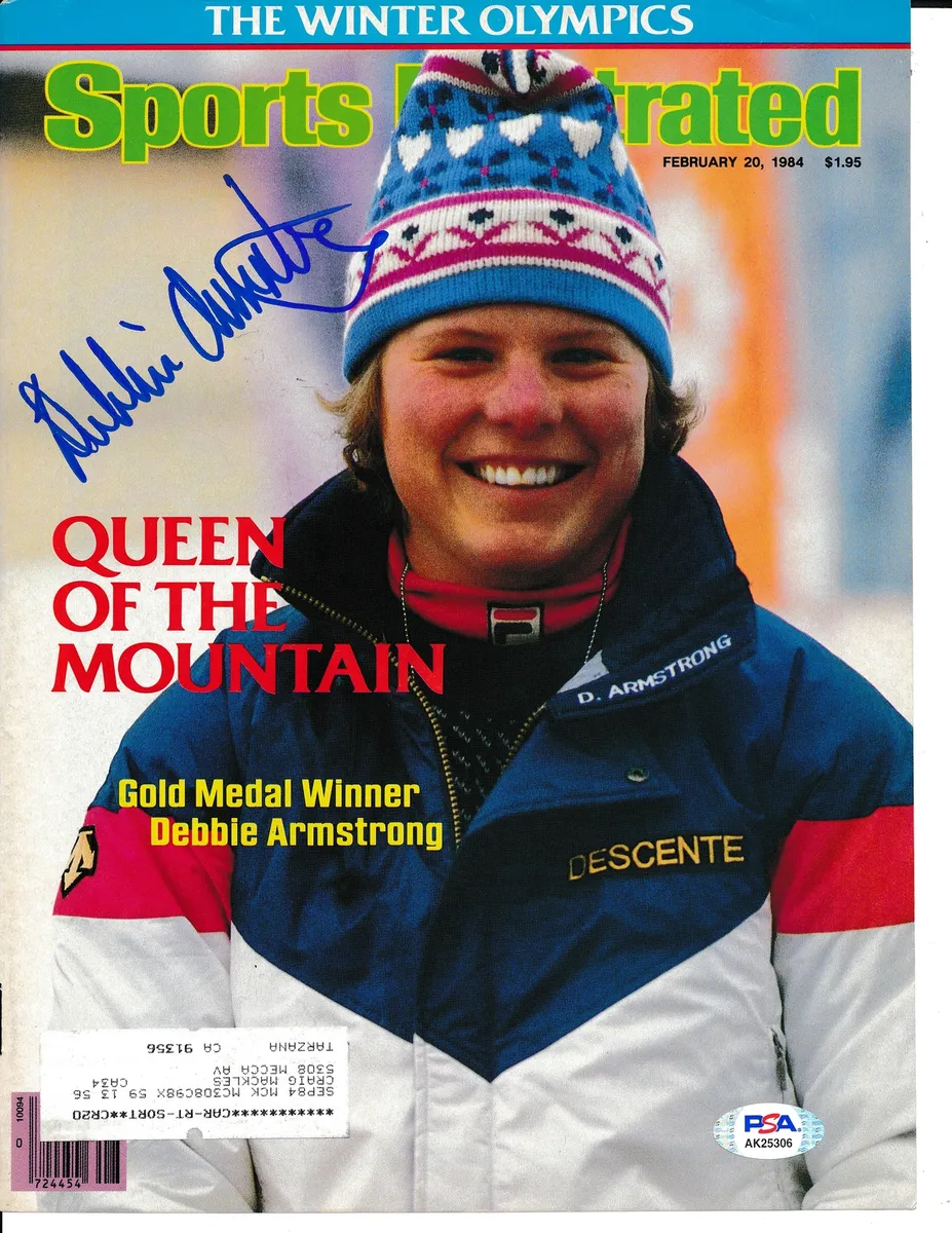 An autographed sports illustrated magazine featuring Deb Armstrong, a woman in a hat, conquering Lost Trail on skis.
