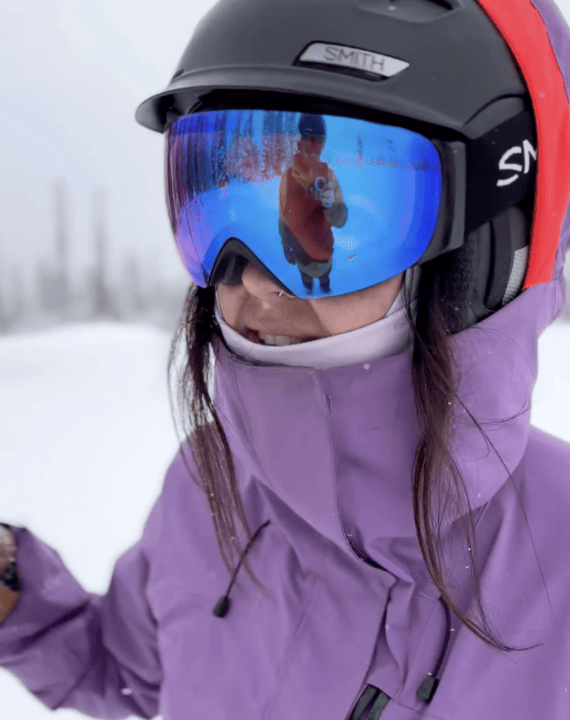 Media Credits: A woman wearing a purple ski helmet and goggles.