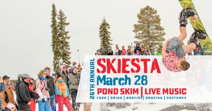 A skier flips backward over a pond in front of a cheering crowd at a ski event, with event details for Skiesta on March 28 displayed in bold text.